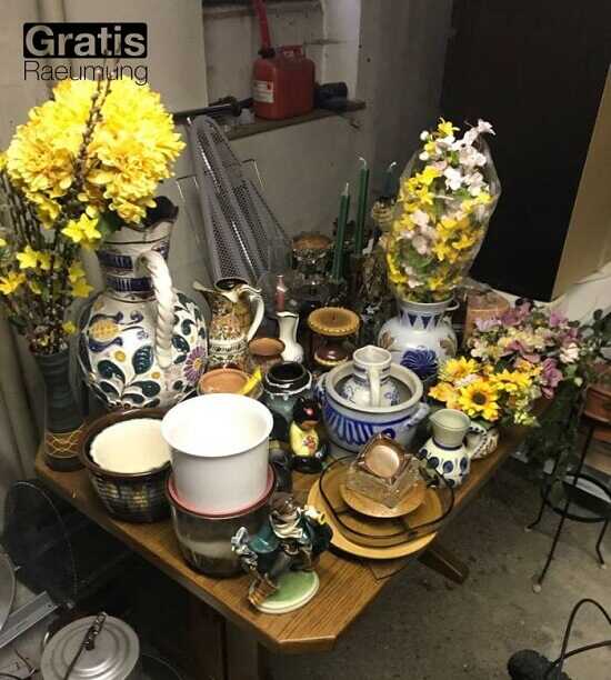 Es gibt alte Vasen, Kerzenständer, Töpfe und einige mit Kunstblumen.